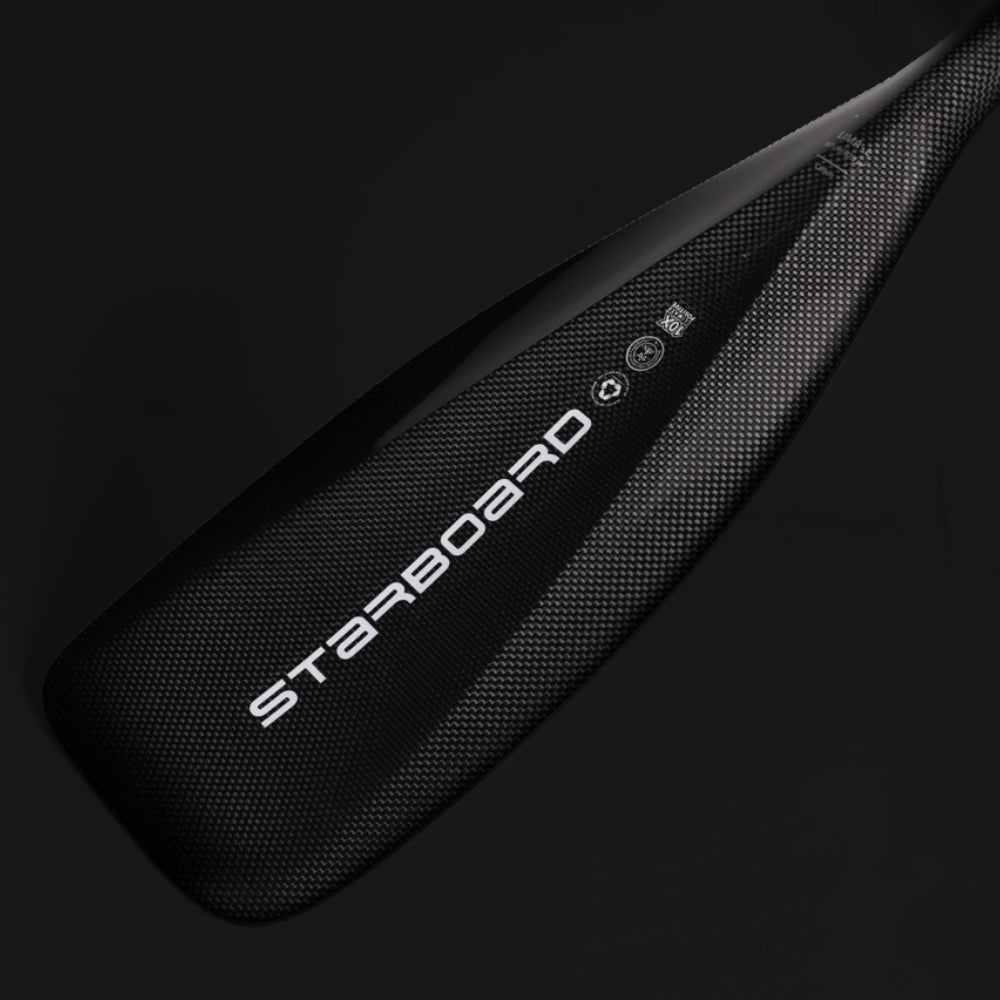 Full view of the two-piece Starboard Lima Carbon adjustable SUP paddle with carbon shaft and black blade.
